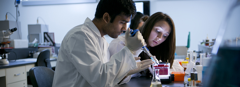 photo of two students working in a lab